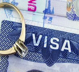 A ring sitting on top of an american visa.