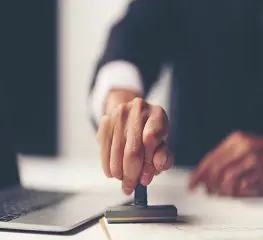 A person is sitting at a desk with a laptop.