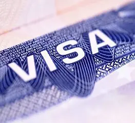 A close up of the word visa on top of a passport.