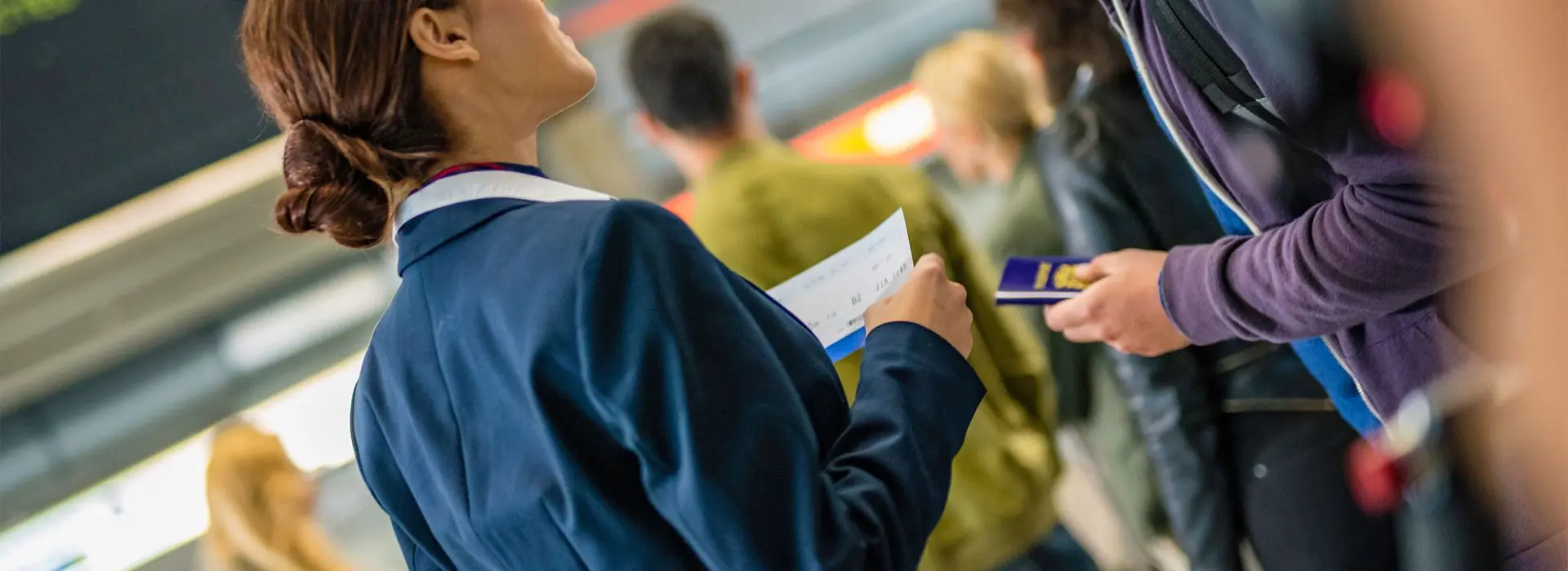 A person holding a phone and looking at papers.