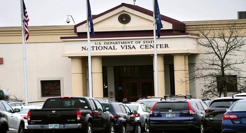 A line of cars parked in front of the national visa center.