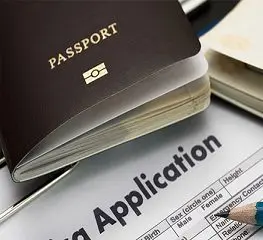 A passport sitting on top of an application form.