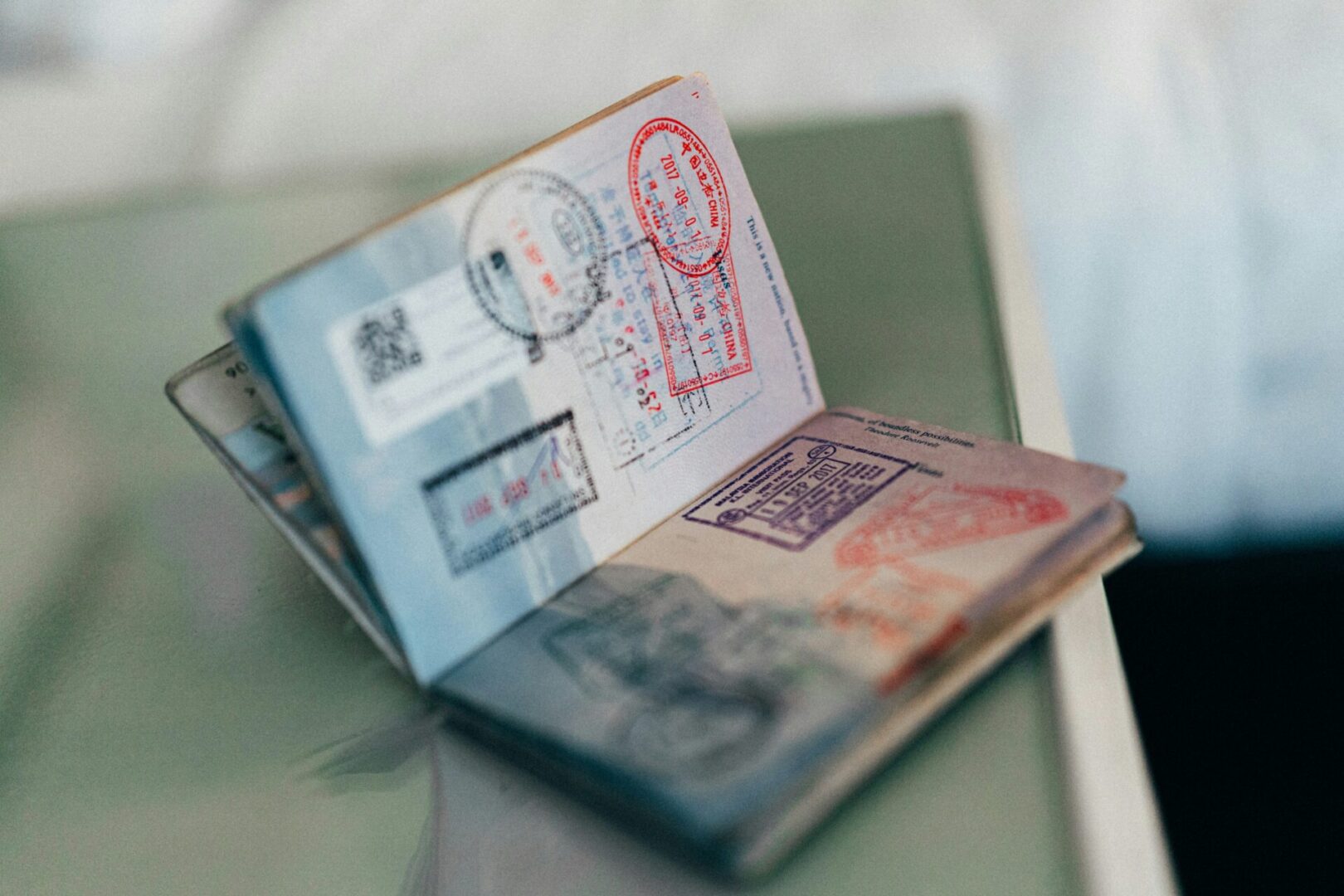 A passport with stamps on it sitting open.