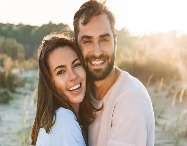 A man and woman smiling for the camera.